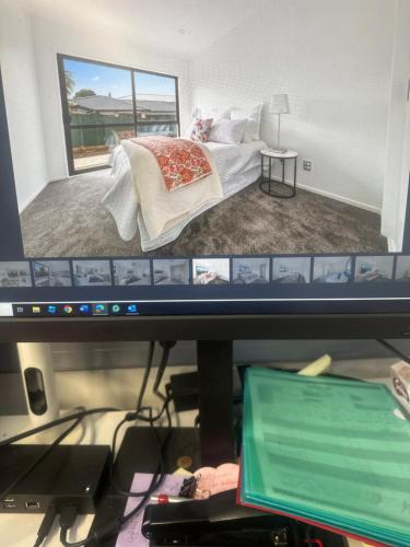 a computer monitor with a drawing of a bedroom at Airport Heaven Comfort Home in Auckland