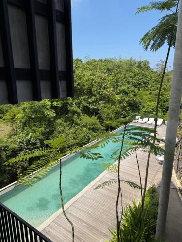 a swimming pool on a balcony of a building at Elegant 3 bedroom Villa in Jimbaran