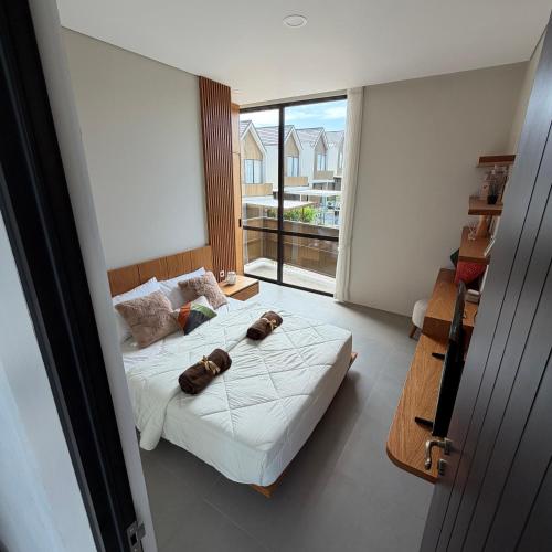 a bedroom with a bed and a large window at Elegant 3 bedroom Villa in Jimbaran