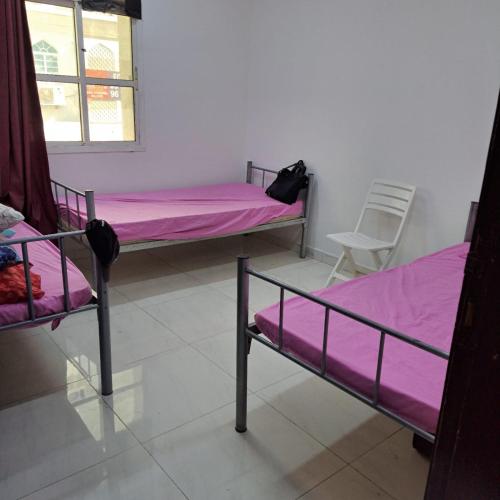 a room with two bunk beds and a window at New mohastel in Muscat
