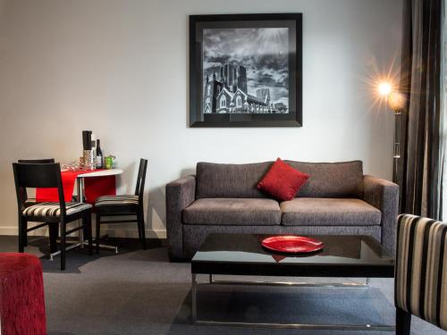 a living room with a couch and a table at Richmond Central Apartments in Melbourne