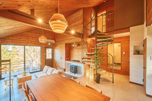 a living room with a table and a fireplace at プライベートリゾート星池 in Yamanakako