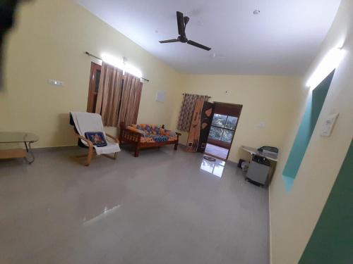 an empty living room with a ceiling fan at RKGroupStays in Tirupati