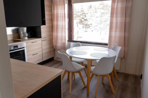 a kitchen with a table and chairs and a window at Apartment 55m2 in Kemijärvi 