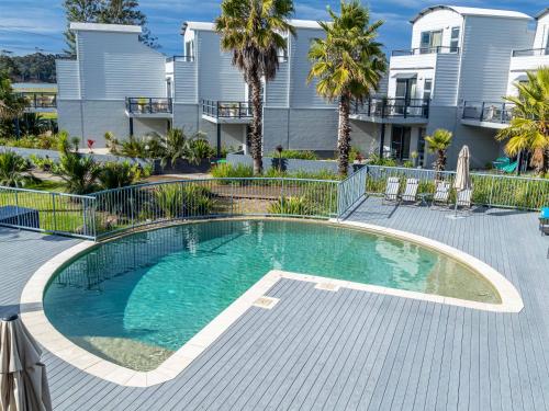 a swimming pool in front of a building at Corrigans Beach Escape 1 Bedroom Apartment in Batemans Bay