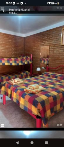 Ένα ή περισσότερα κρεβάτια σε δωμάτιο στο Hostería huanel
