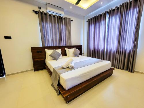 a bedroom with a large bed in front of a window at Lavinia Beach Hotel Ambalangoda in Ambalangoda
