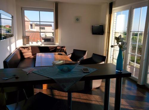 a living room with a table and a couch at Heiligenhafen Doppel-Seeblick in Heiligenhafen