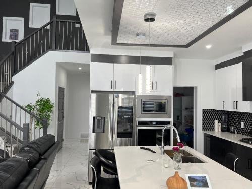 a kitchen and living room with a couch and a table at Private room with full washroom in Edmonton