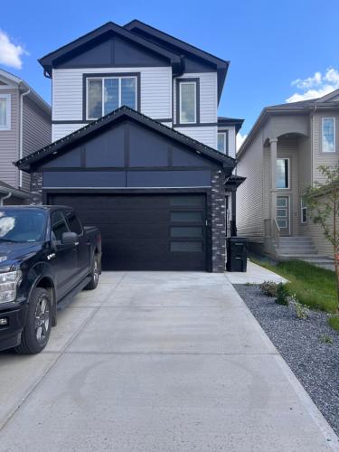 a garage with a car parked in front of a house at Private room with full washroom in Edmonton