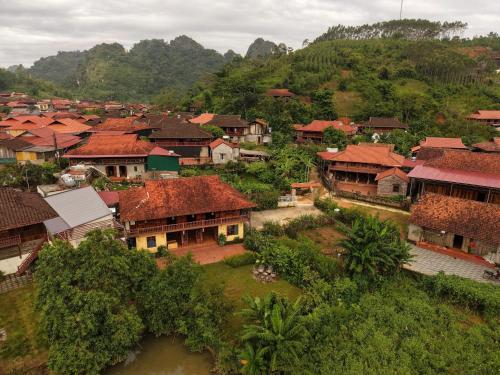 an aerial view of a village with houses and a river at ThongDong Homestay in Hữu Lũng