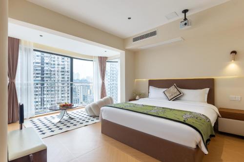 a bedroom with a large bed and a large window at Skyline Riverview Apartments in Chongqing