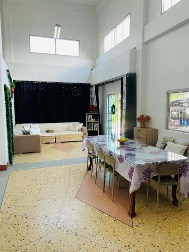 a large living room with a table and chairs at CozyRooms Korat in Ban Nong Bo