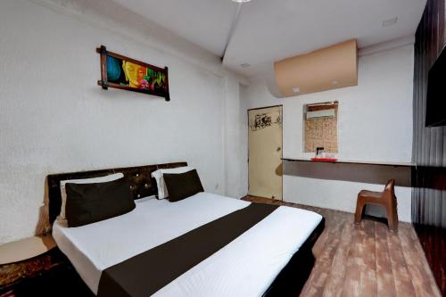 a bedroom with a large white bed and a chair at Collection O Lokmanya Nagar Metro Station Formerly Hotel Siddhivinayak in Rāipur