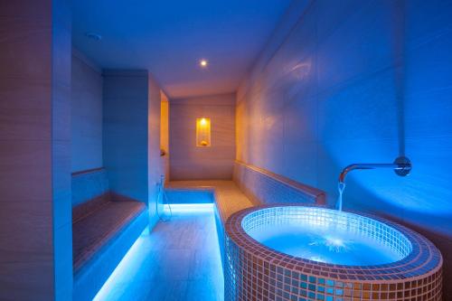 a bathroom with a tub in the middle of the room at Hotel Terme Cristoforo in Abano Terme