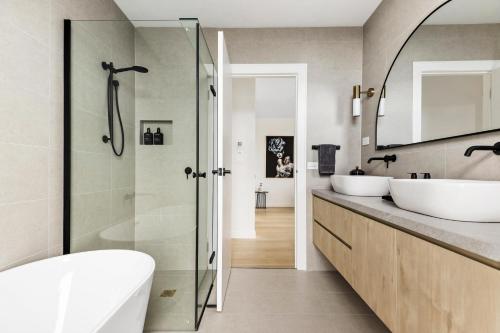 a bathroom with two sinks and a shower at Ivanhoe Five Luxury Holiday Home 4 Bed Sleep 6 in Melbourne