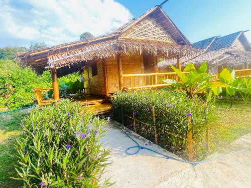 a small hut with a thatched roof at Wooden House Koh Lanta in Ko Lanta Yai