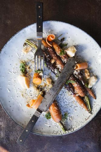 a plate of food with a fork and knife at Siggesta Gård in Värmdö