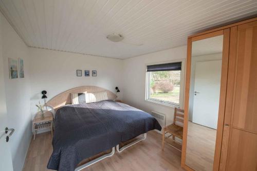 a bedroom with a bed and a window in it at Cottage With Panoramic View Of Lammefjorden in Holbæk