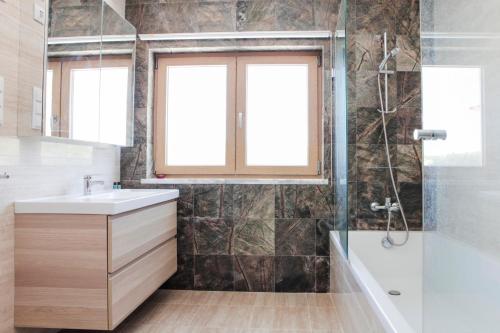 a bathroom with a sink and a shower at Monte Girassol - The Lisbon Country House in Quinta das Faias