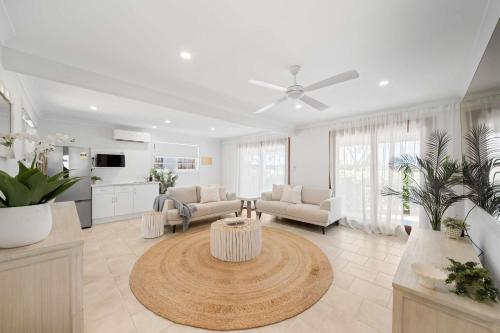 a living room with a couch and a table at Absolute Beachfront Paradise in Buddina in Buddina