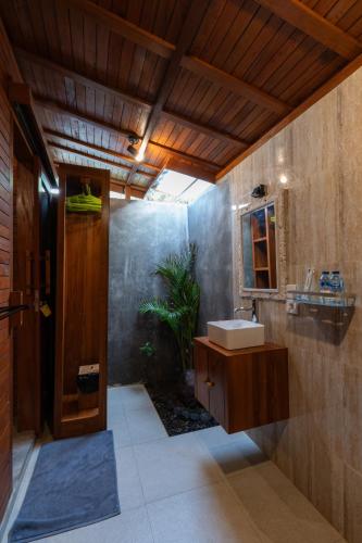 a bathroom with a sink and a mirror at Arta Bali Glamping in Tianyar