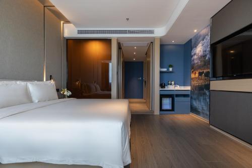 Ένα ή περισσότερα κρεβάτια σε δωμάτιο στο Atour Hotel (Wuhan Qingshan Peace Park)