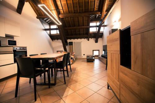 a kitchen and dining room with a table and chairs at Penthouse at the Monument in Trichiana