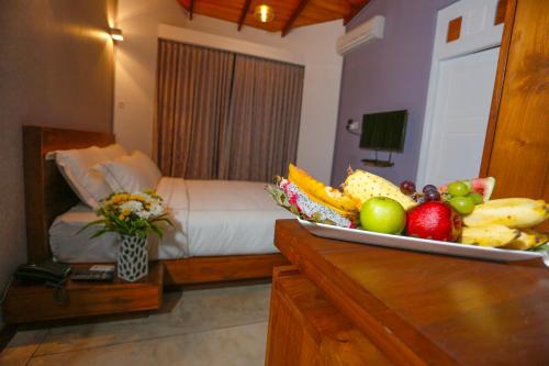 a hotel room with a tray of fruit on a counter at Viyana Boutique Hotel in Kandy