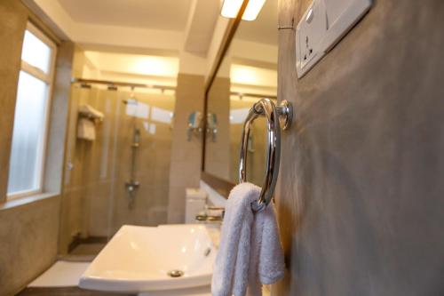 a bathroom with a sink and a towel at Viyana Boutique Hotel in Kandy