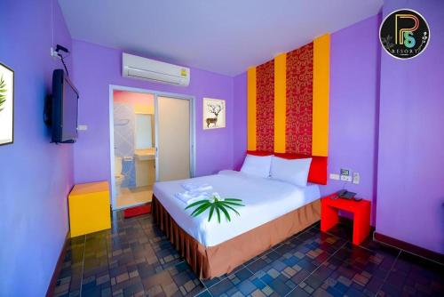 En eller flere senge i et værelse på PS Resort