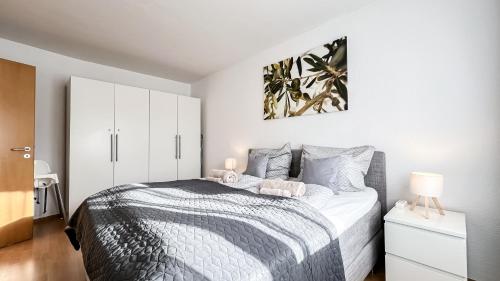 a bedroom with a bed and a white cabinet at Ferienwohnung in der Stadt mit kostenfreier Tiefgarage bis 1,50m Fahrzeughöhe - 2 Doppelbetten, Küche, Bad in Leipzig