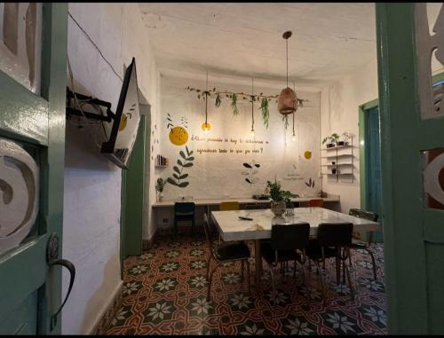 a dining room with a table and some chairs at Hostal Prana in Abejorral