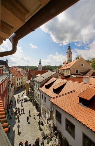 a group of people walking around a street in a city at Pension Zámecká Apartmá - Castle Apartments in Český Krumlov