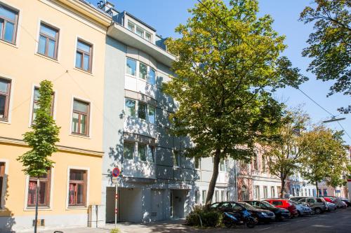 a building on a street with cars parked in front at Residenz Donaucity in Vienna