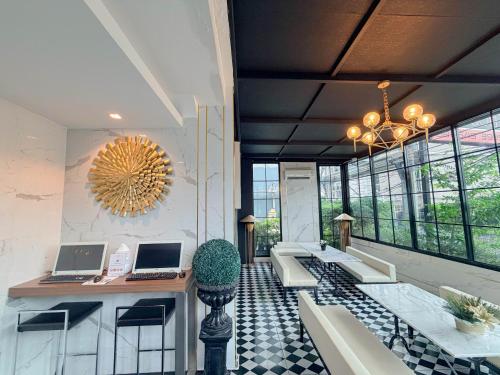 a lobby with two laptops on a table and chairs at Marigold Sukhumvit - Free Shuttle to BTS Bearing Station in Bangkok