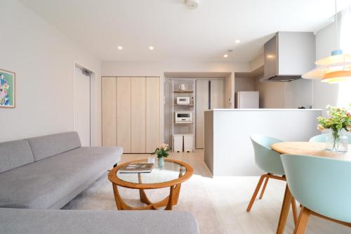 a living room with a couch and a table at Ken's Place Azabu-Juban in Tokyo