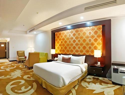 Ένα ή περισσότερα κρεβάτια σε δωμάτιο στο Grand Basko Hotel