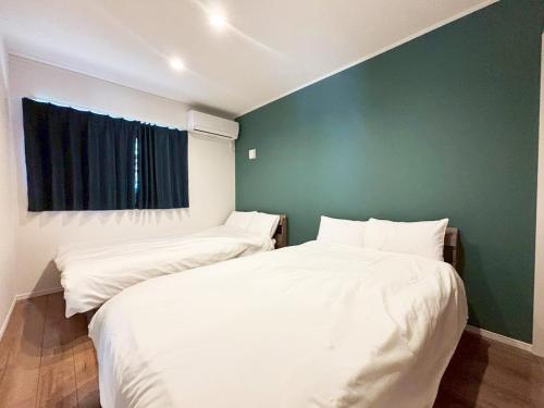 Ένα ή περισσότερα κρεβάτια σε δωμάτιο στο VILLA BLUEOCEAN AWAJIYA NORTHヴィラブルーオーシャン淡路屋north