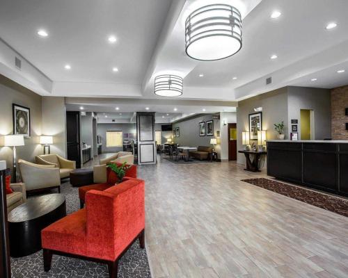 a lobby of a hotel with a red chair and furniture at Comfort Suites Northwest - Cy - Fair in Houston