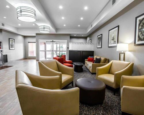a lobby with couches and chairs and a fireplace at Comfort Suites Northwest - Cy - Fair in Houston