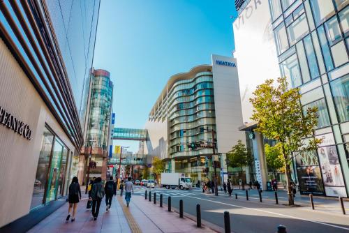 a group of people walking down a city street at HOTEL MYSTAYS Fukuoka Tenjin in Fukuoka