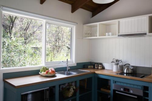 una cocina con fregadero y ventana en Werriberri, en Medlow Bath
