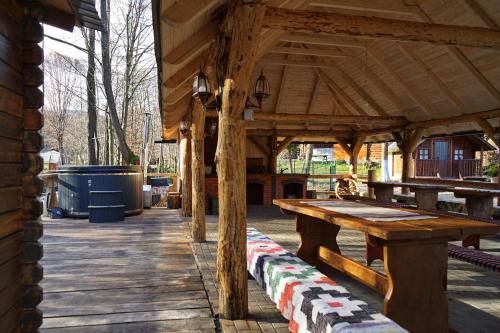 a wooden pavilion with a wooden table on a patio at Cabana Victor in Sighetu Marmaţiei
