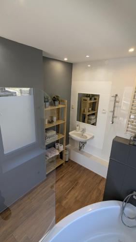 a bathroom with a white tub and a sink at Agroturystyka SPA in Zelków