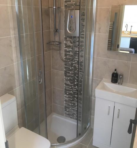 a bathroom with a shower and a toilet and a sink at Russet in Yate