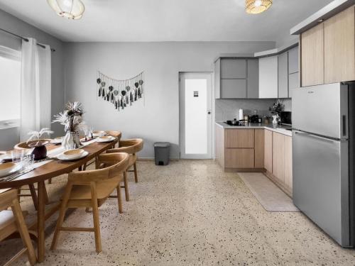 a kitchen with a table with chairs and a refrigerator at Casa Cueva Beach House for 14 PPL in Arecibo in Arecibo