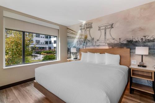 a bedroom with a large bed and a window at Cambria Hotel Portland Downtown Old Port in Portland