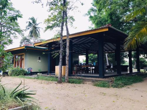 a house with a pavilion in front of it at Wewlekam Safari Resort 