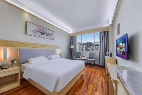 Ένα ή περισσότερα κρεβάτια σε δωμάτιο στο Galaxy Hotel Guangzhou